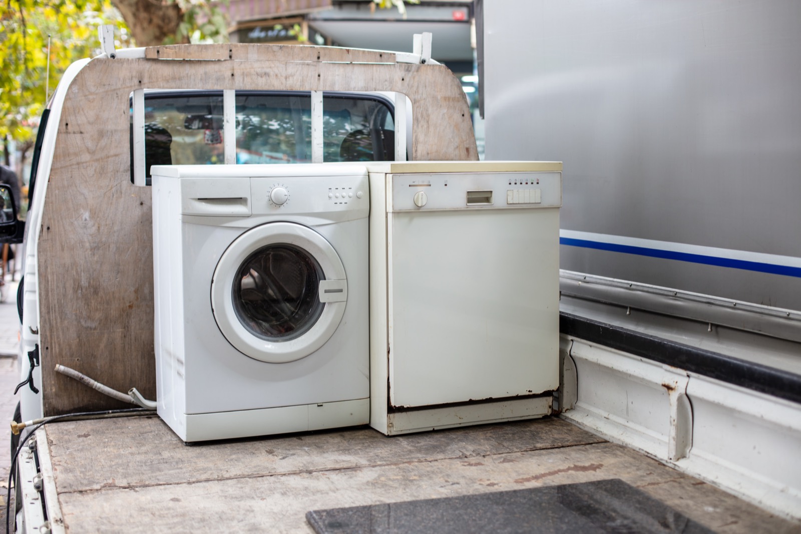 Old refrigerator and washing machine waiting for removal